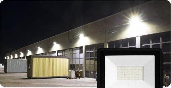 LED floodlights lighting a factory building exterior at night