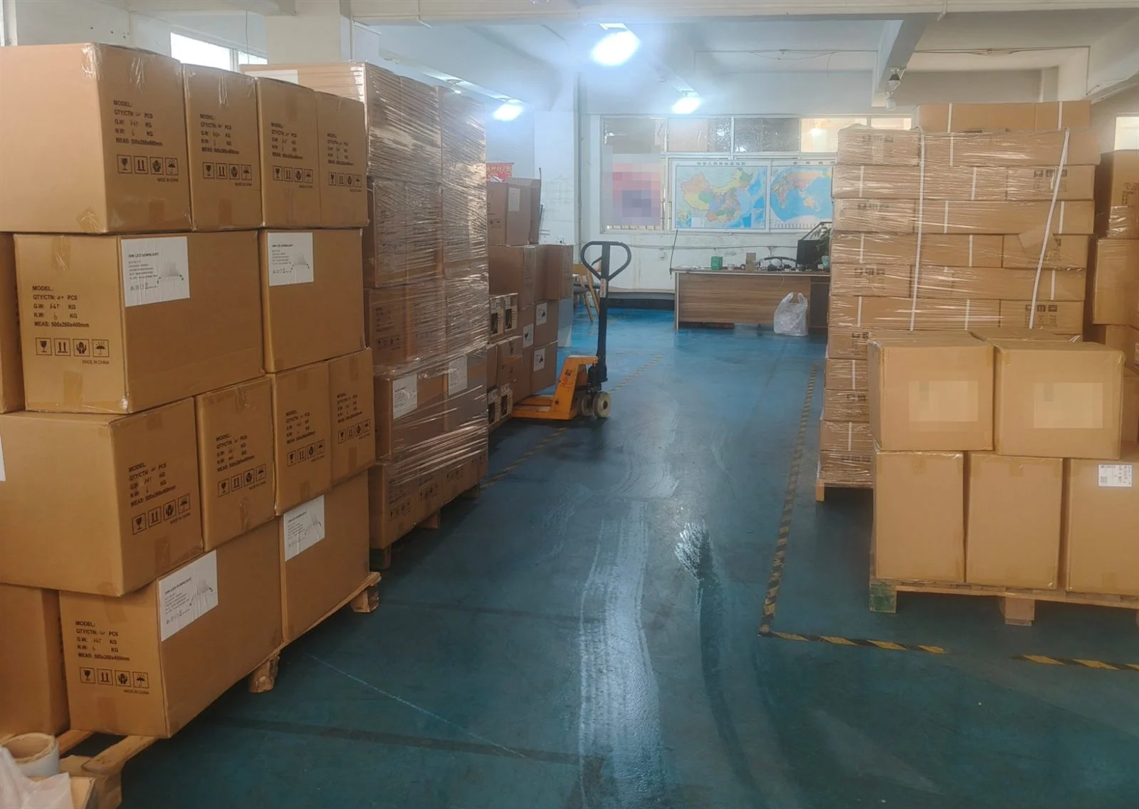 LED lighting cartons from several product lines staged in a Zhongshan warehouse before container loading