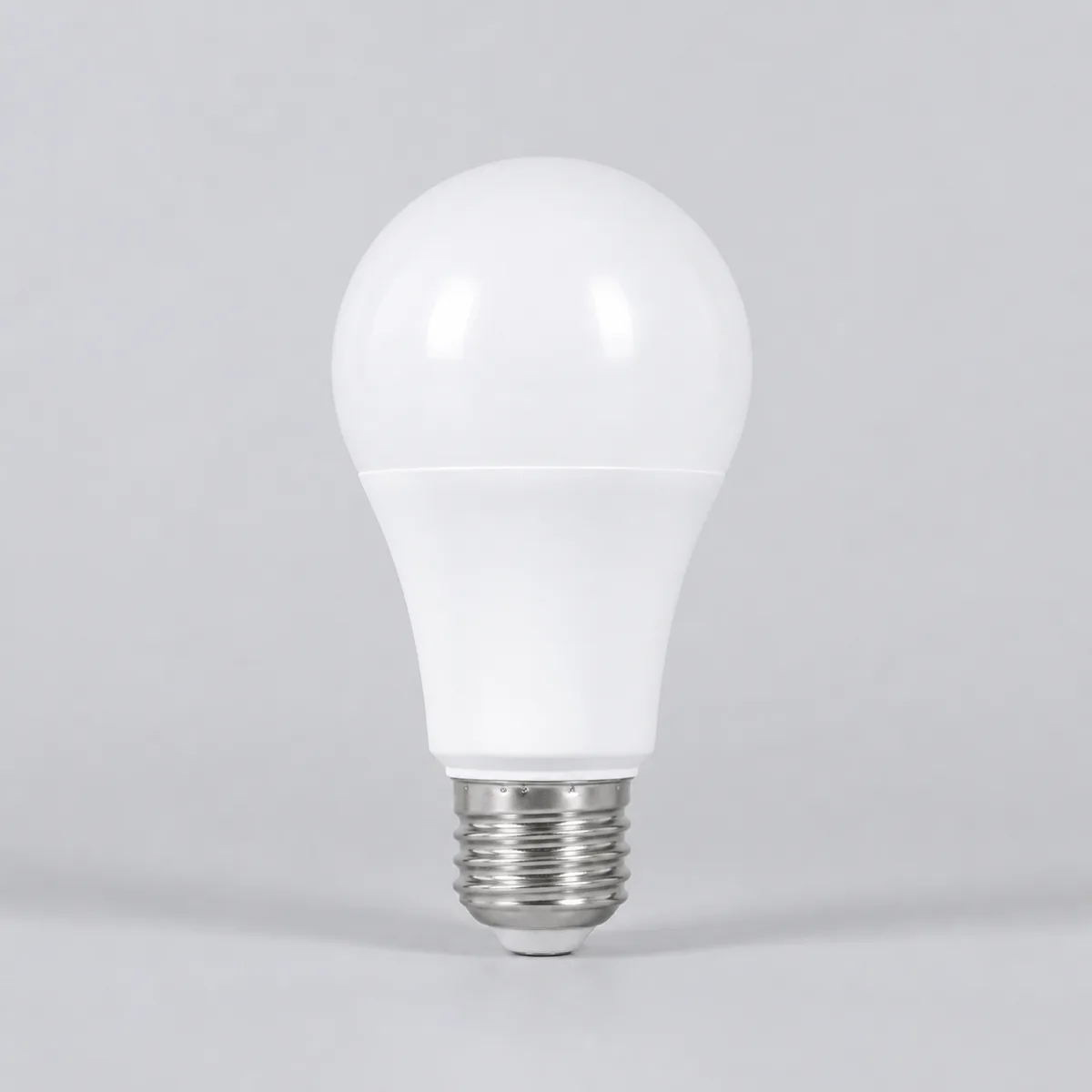 Representative white A60 LED bulb with E27 base on a light background