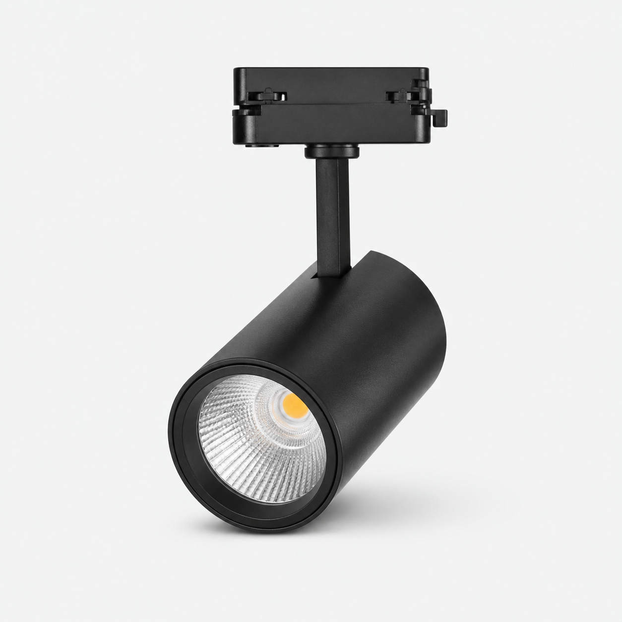 Representative black cylindrical LED track light on a light studio background